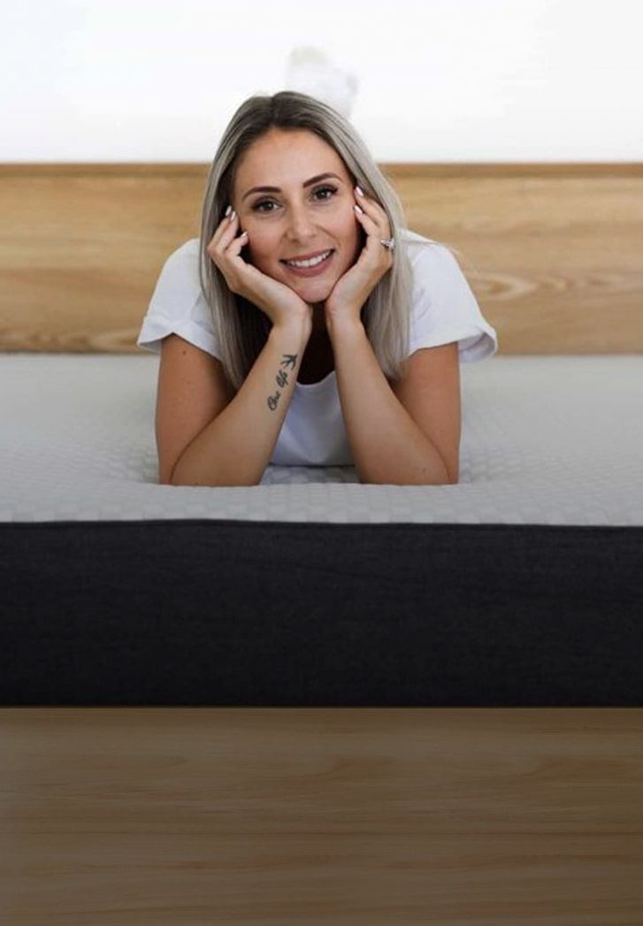 Lady laying on Sophie Mattress in a bedframe