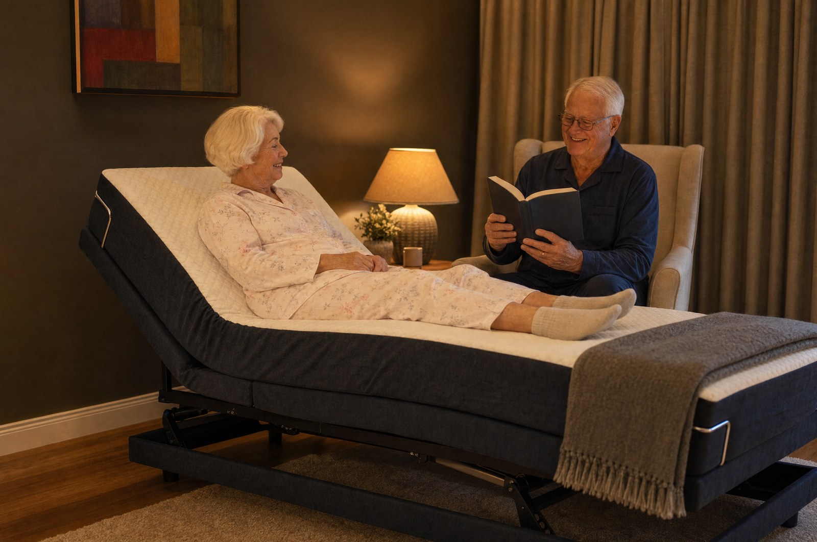 An older couple reading together in the evening beside a Sophie HiLo Adjustable Bed in a Hobart bedroom