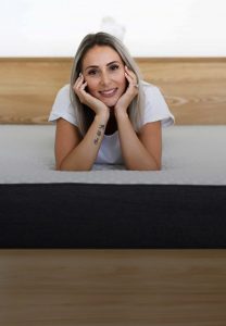 Lady laying on Sophie Mattress in a bedframe